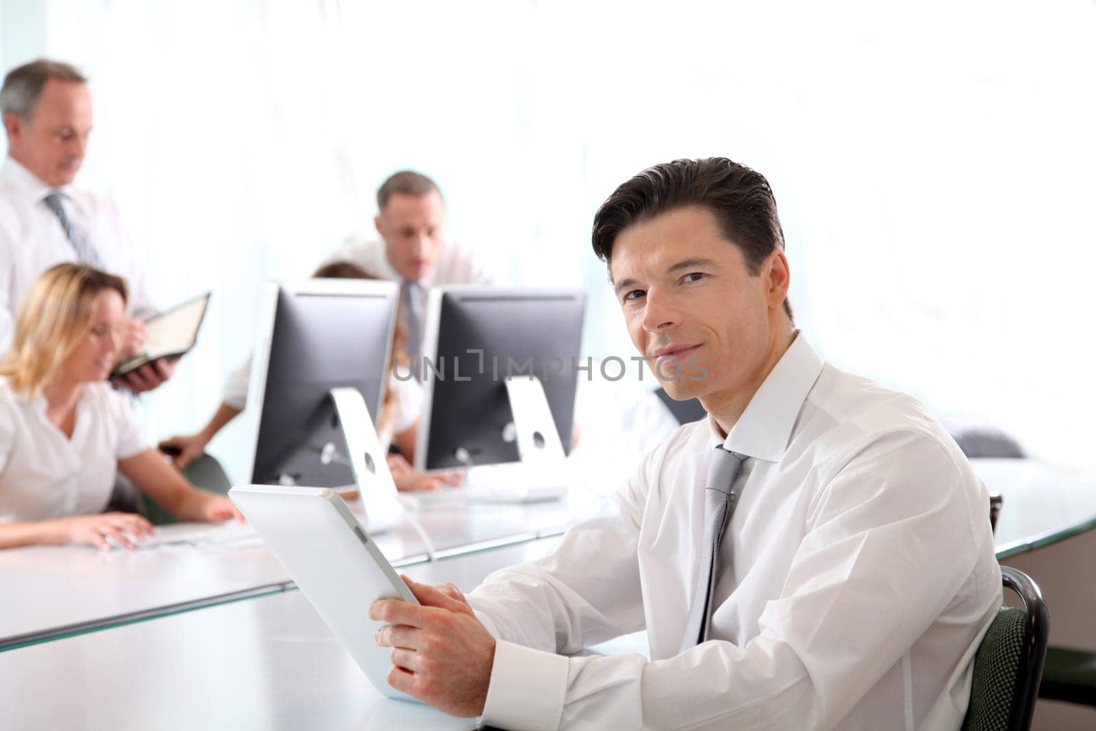 Office worker using electronic tablet in office