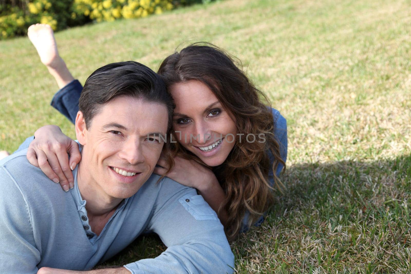 Couple relaxing in home garden
