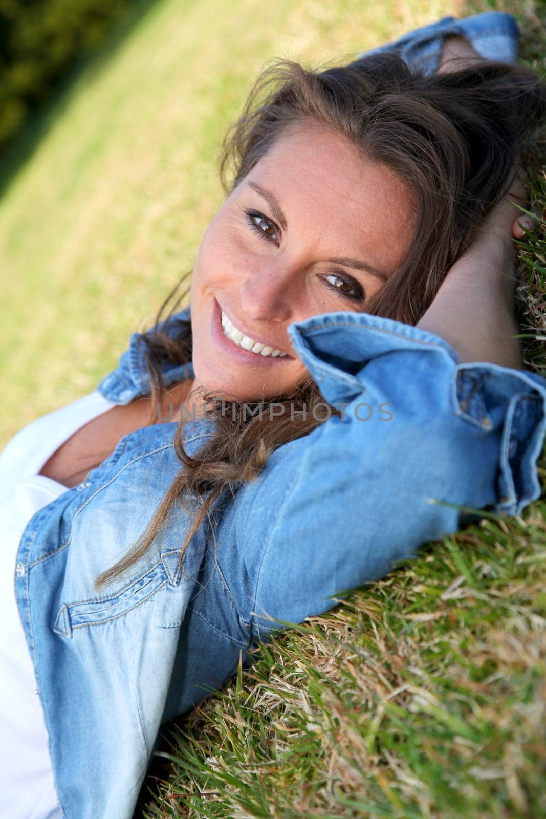 Beautiful woman laying down in the grass