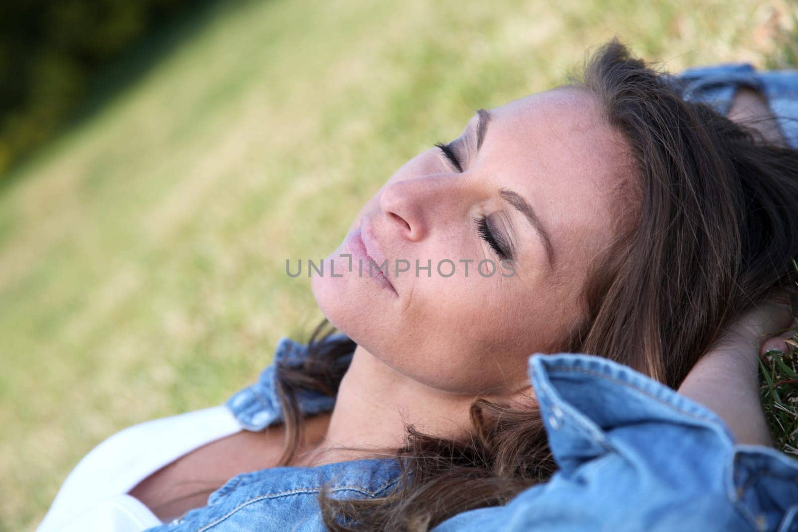 Beautiful woman laying down in the grass