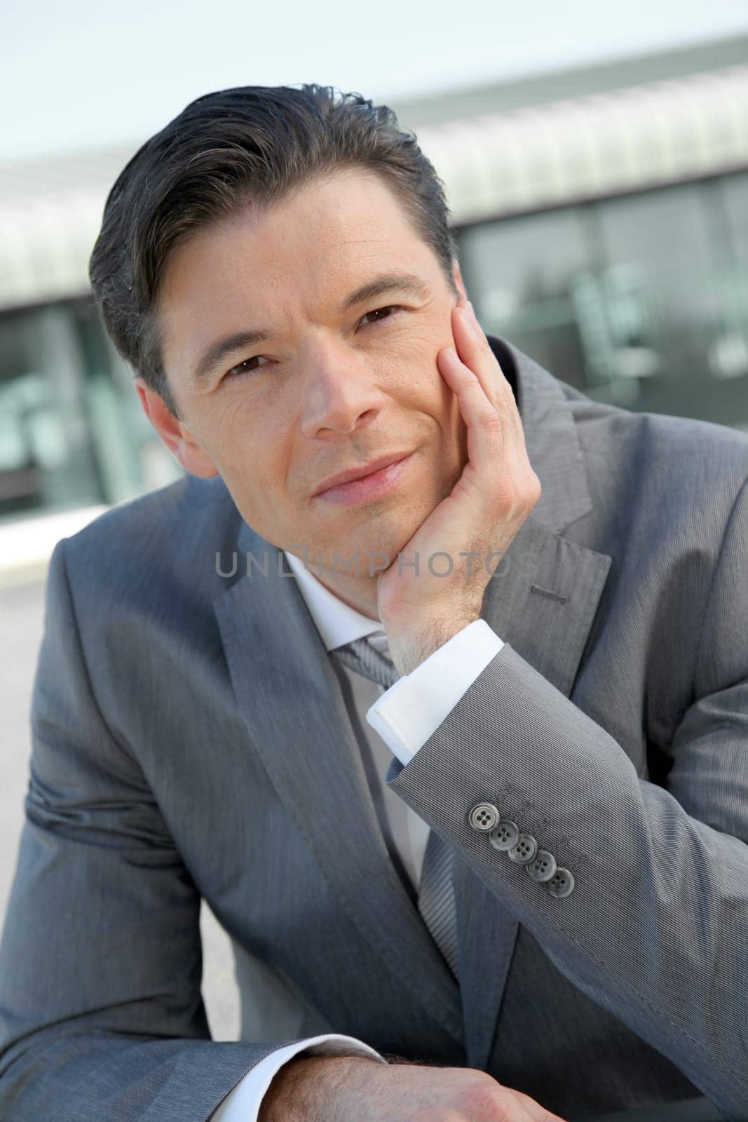 Portrait of businessman standing outside the office