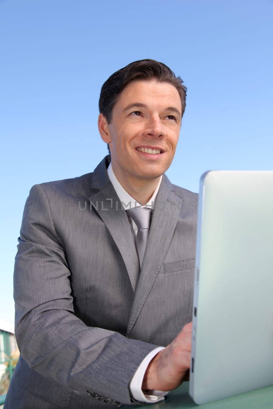 Portrait of businessman working on electronic tablet