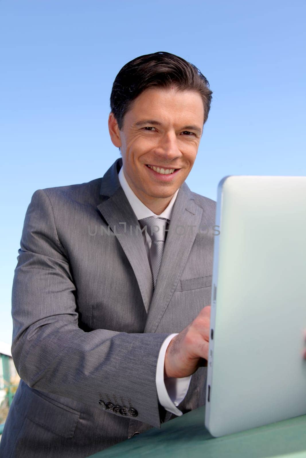 Portrait of businessman working on electronic tablet