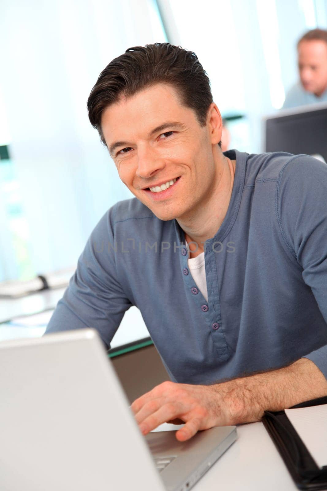 Portrait of office worker in front of laptop computer