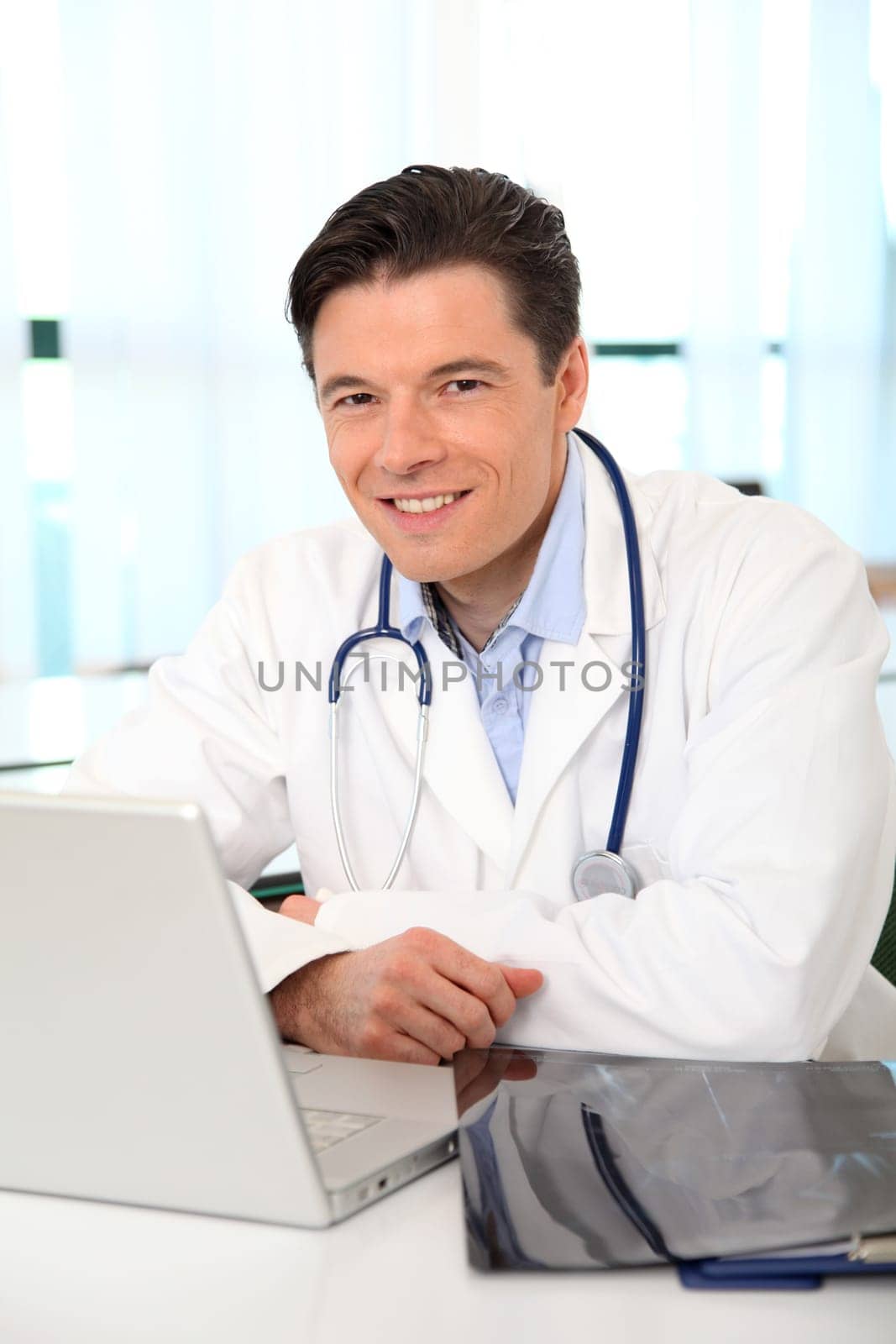 Portrait of smiling doctor working in the office