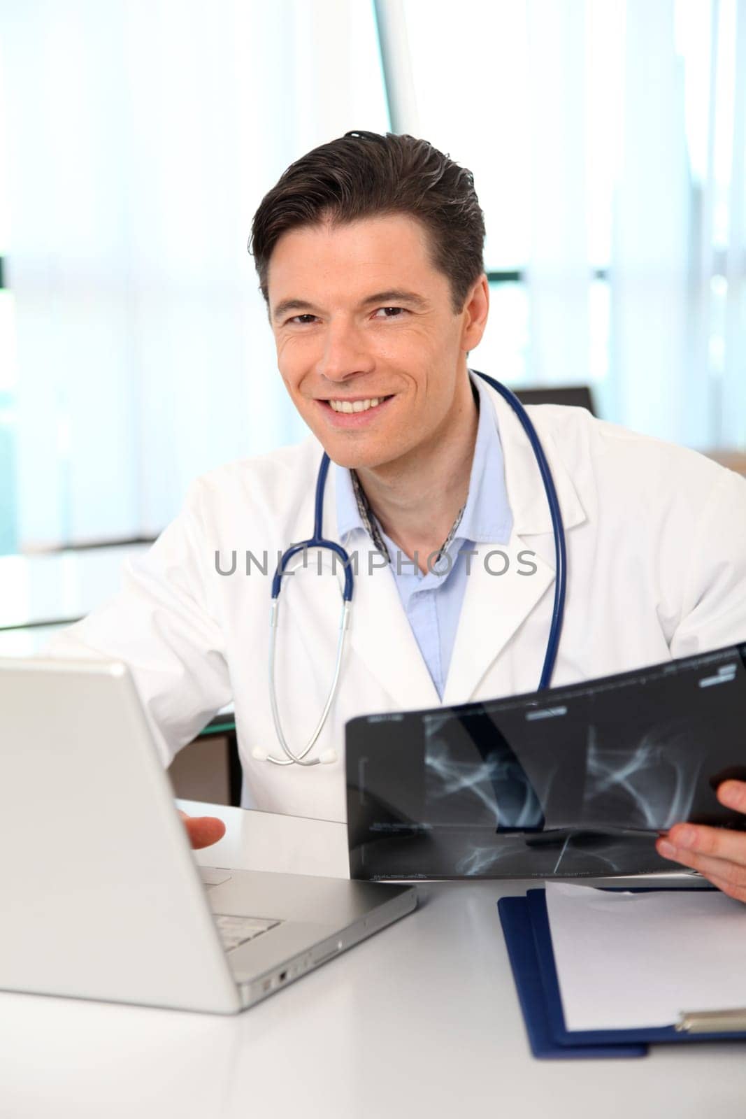 Portrait of smiling doctor working in the office