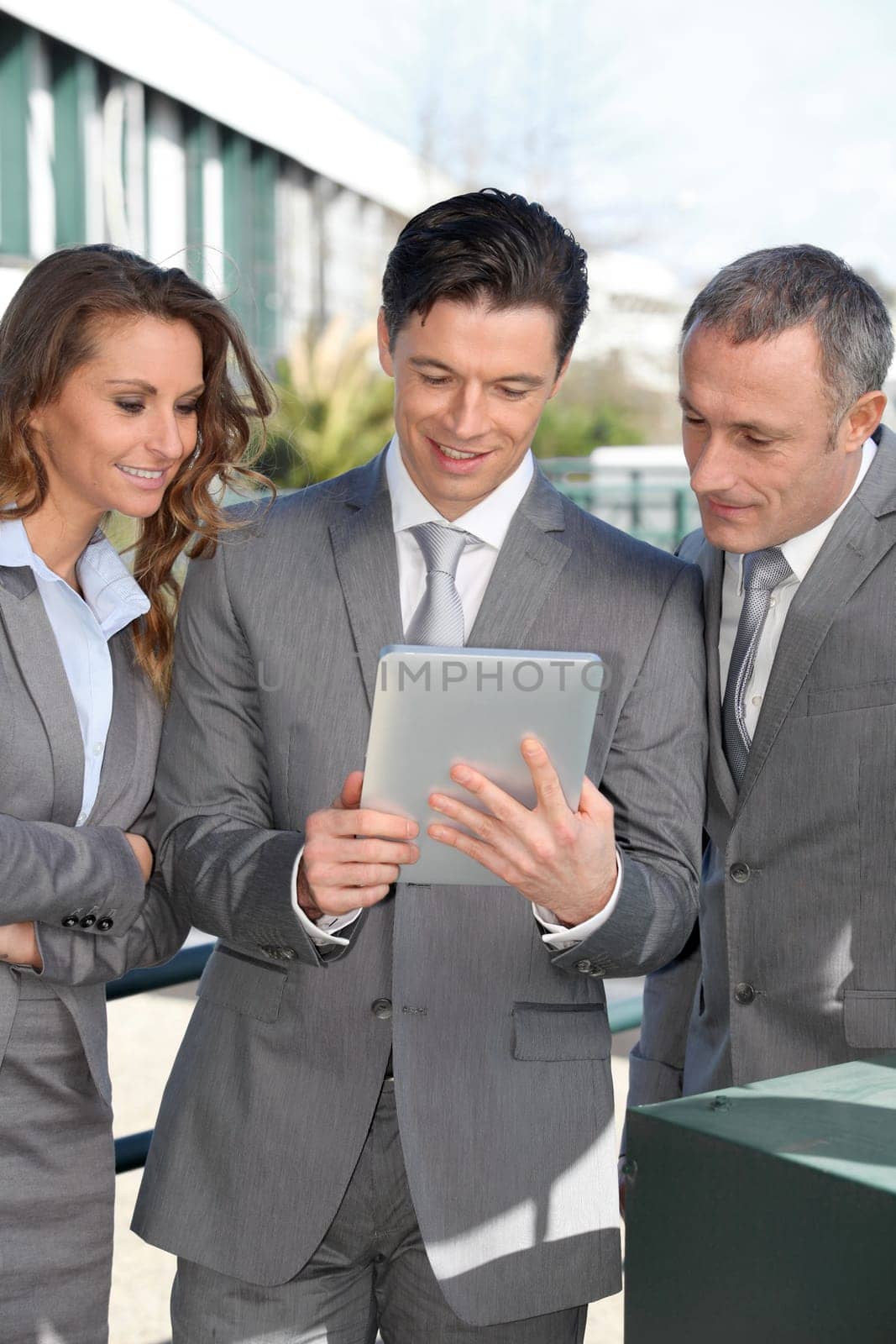 Business people meeting outside with electronic tablet