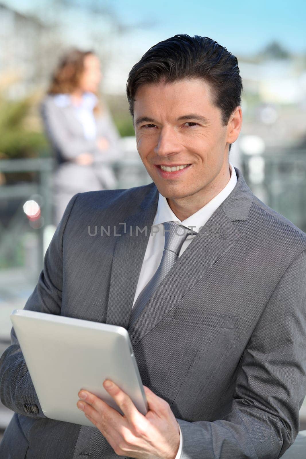 Portrait of businessman working on electronic tablet