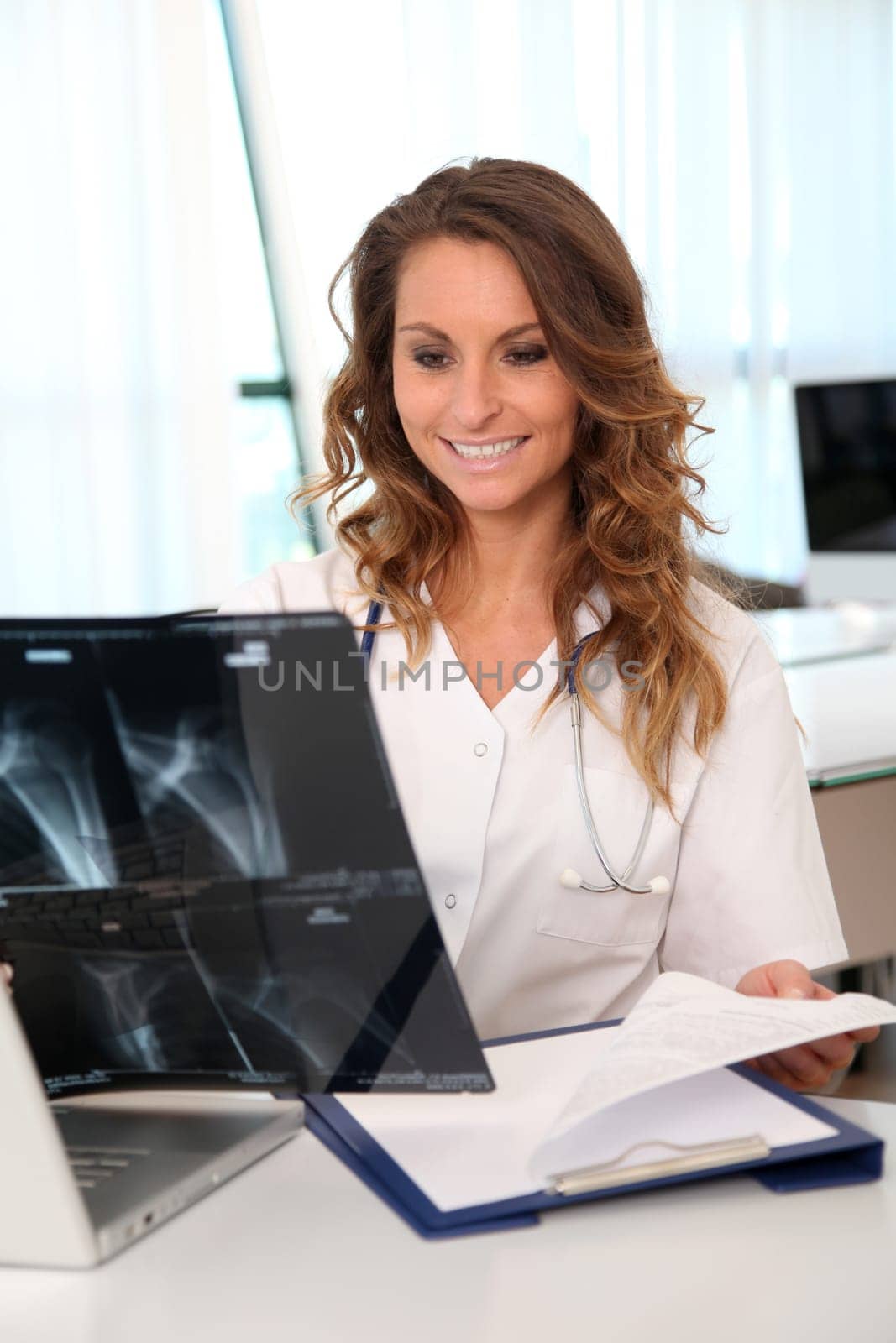 Nurse looking at X-ray in the office