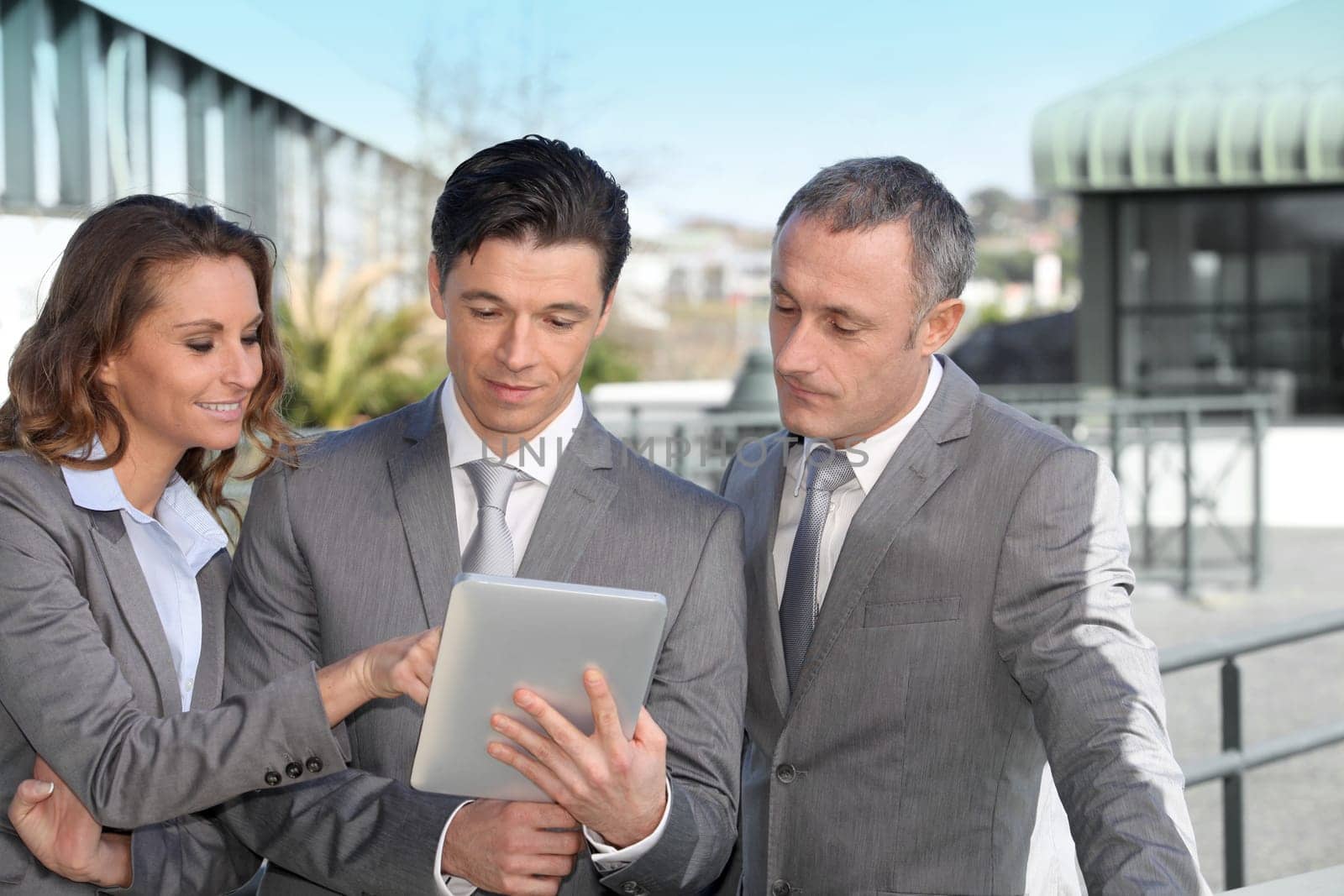 Business people meeting outside with electronic tablet