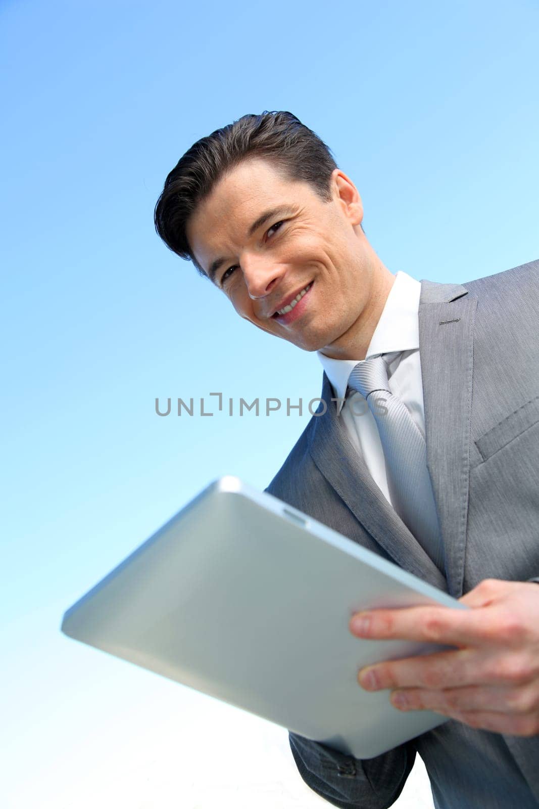 Portrait of businessman working on electronic tablet