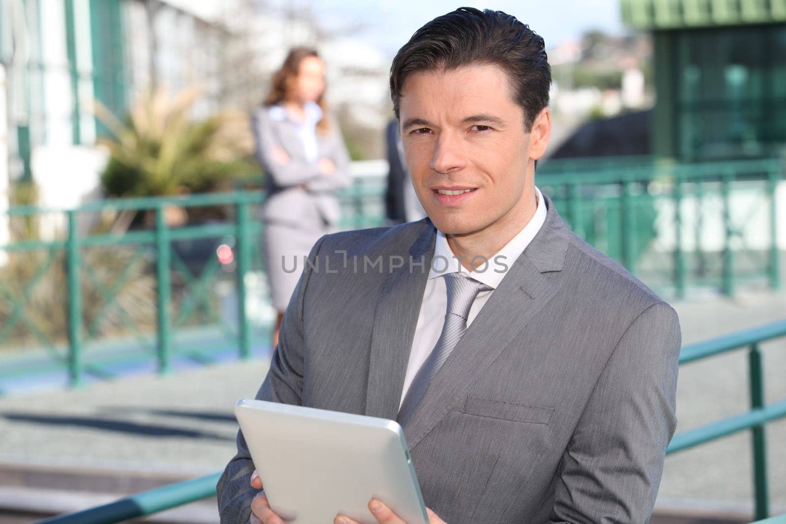 Portrait of businessman working on electronic tablet