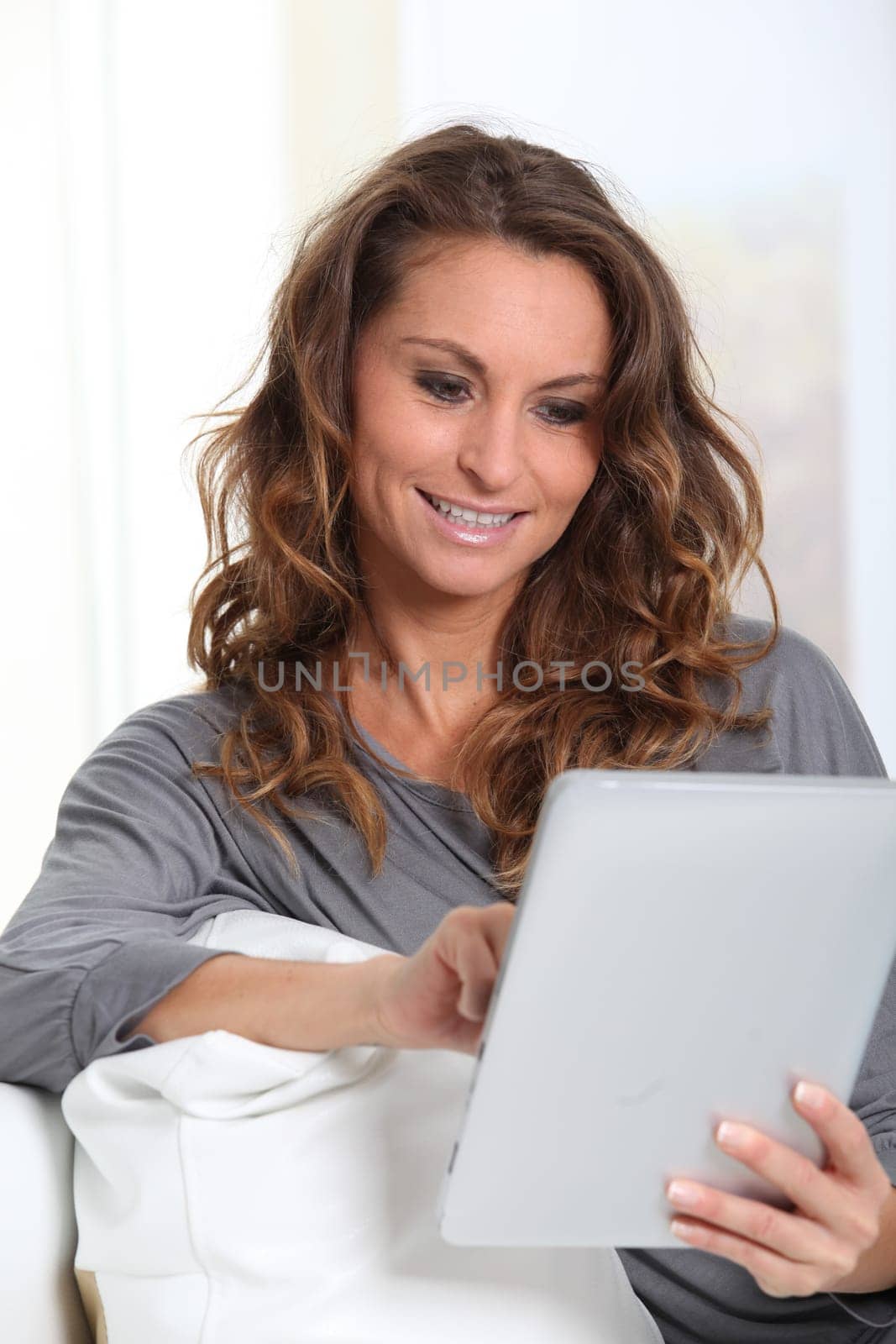 Beautiful woman connected on internet with electronic tablet
