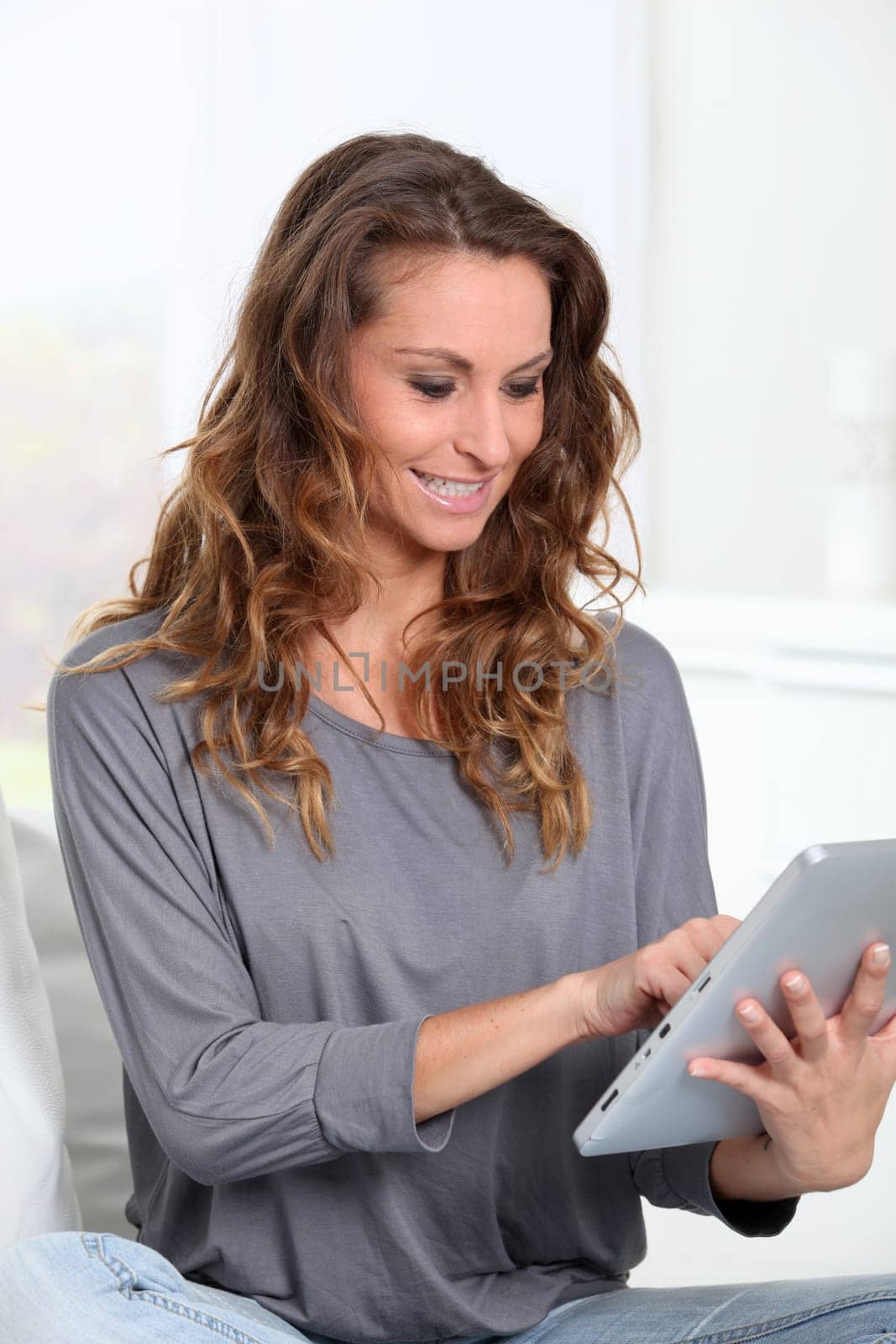 Beautiful woman connected on internet with electronic tablet