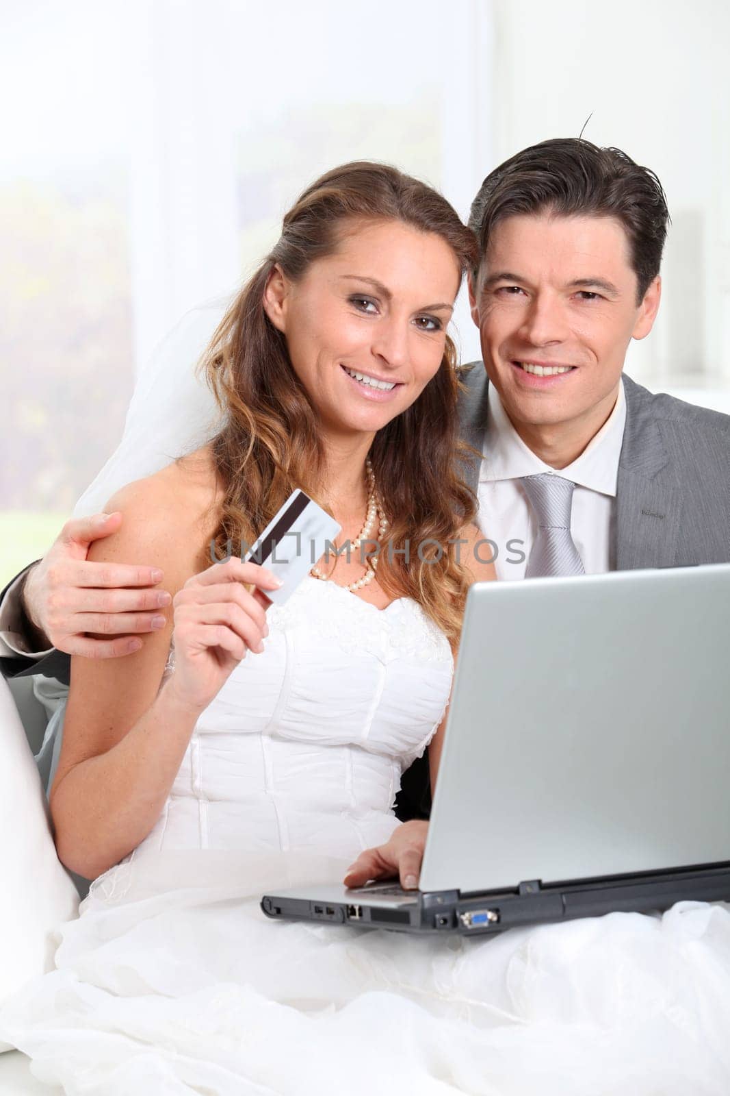 Bride and groom doing shopping on inernet at home