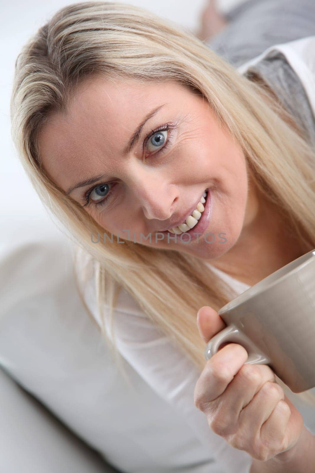Portrait of beautiful blond woman drinking tea