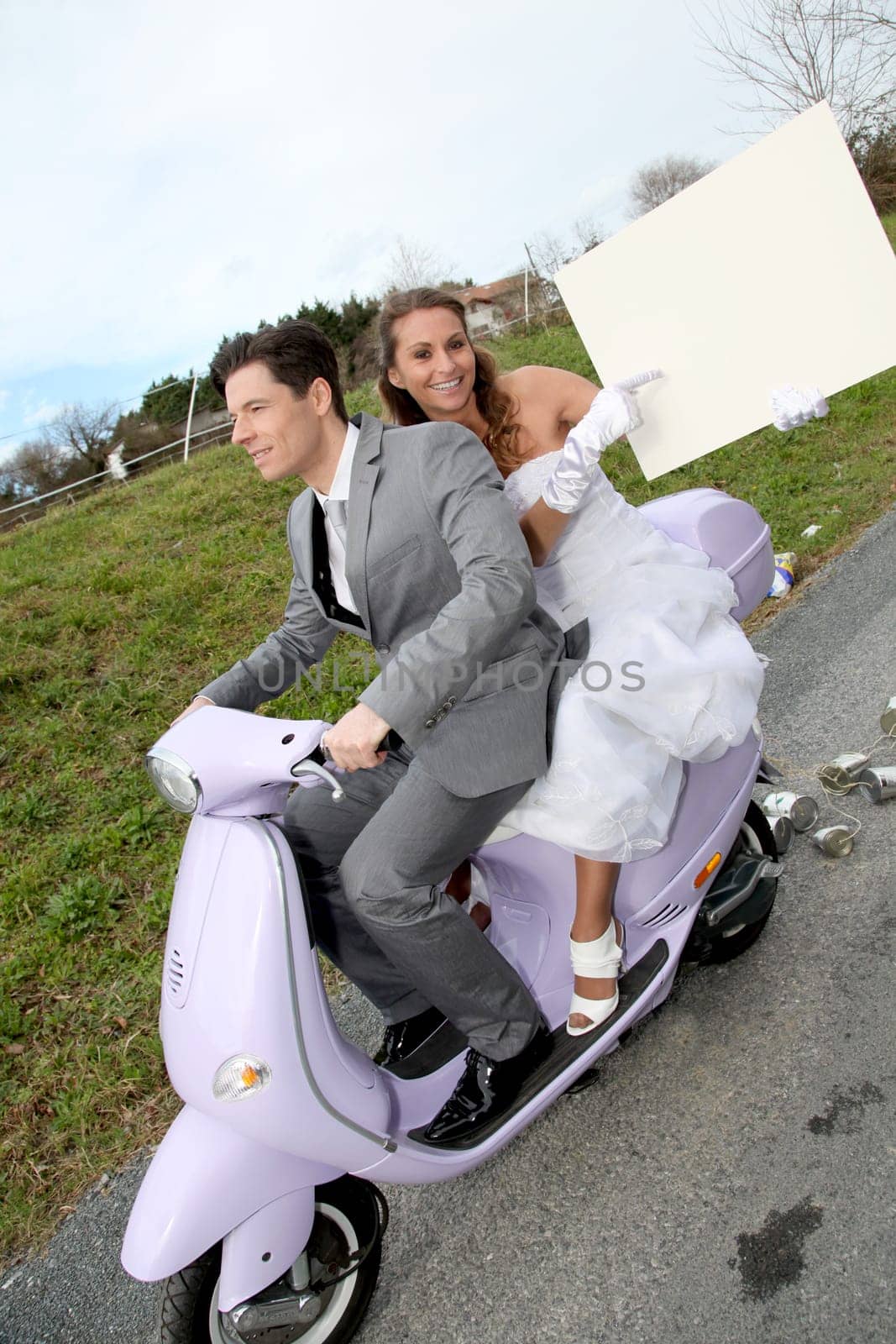 Bride on a motorcycle ride holding whiteboard