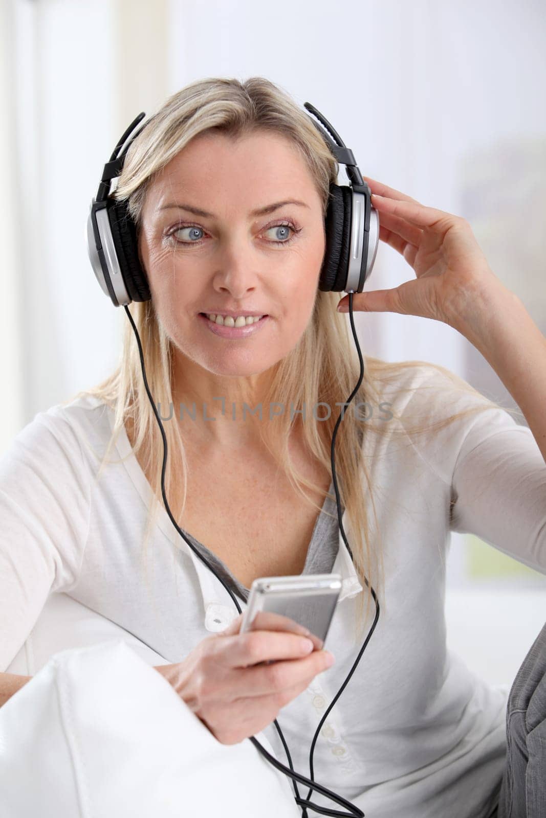 Portrait of beautiful blond woman with headphones on