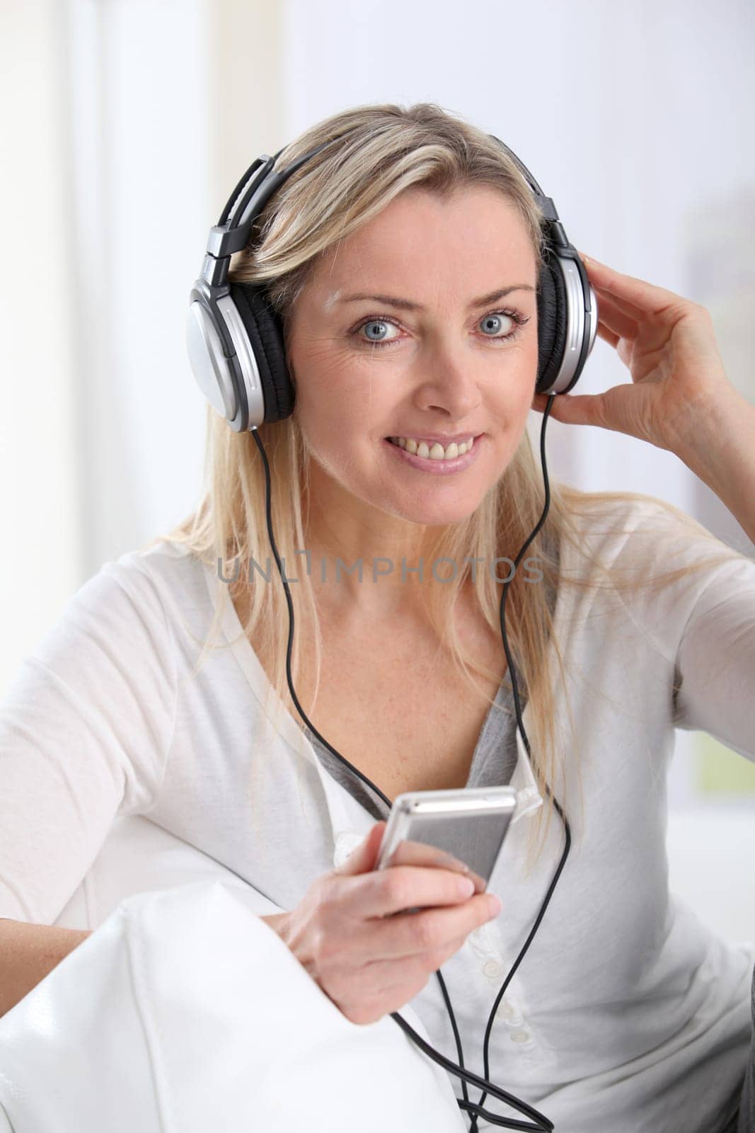 Portrait of beautiful blond woman with headphones on