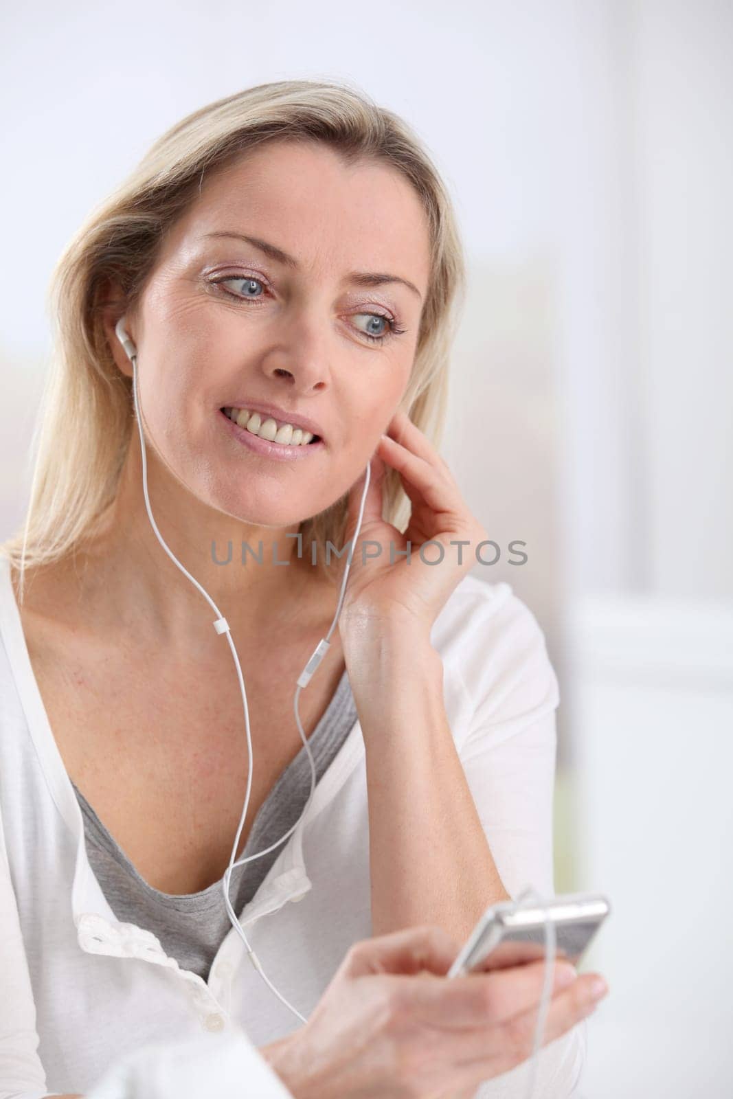 Beautiful blond woman listening to music