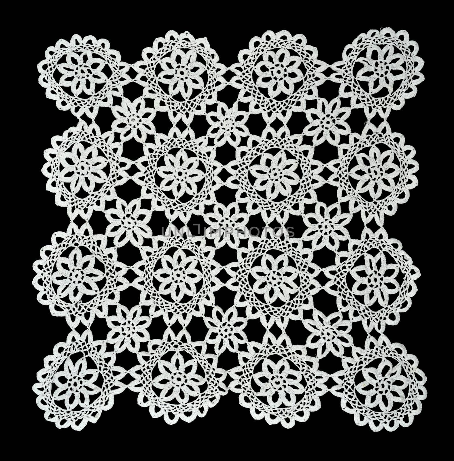 White handmade lace (square form), isolated on black.