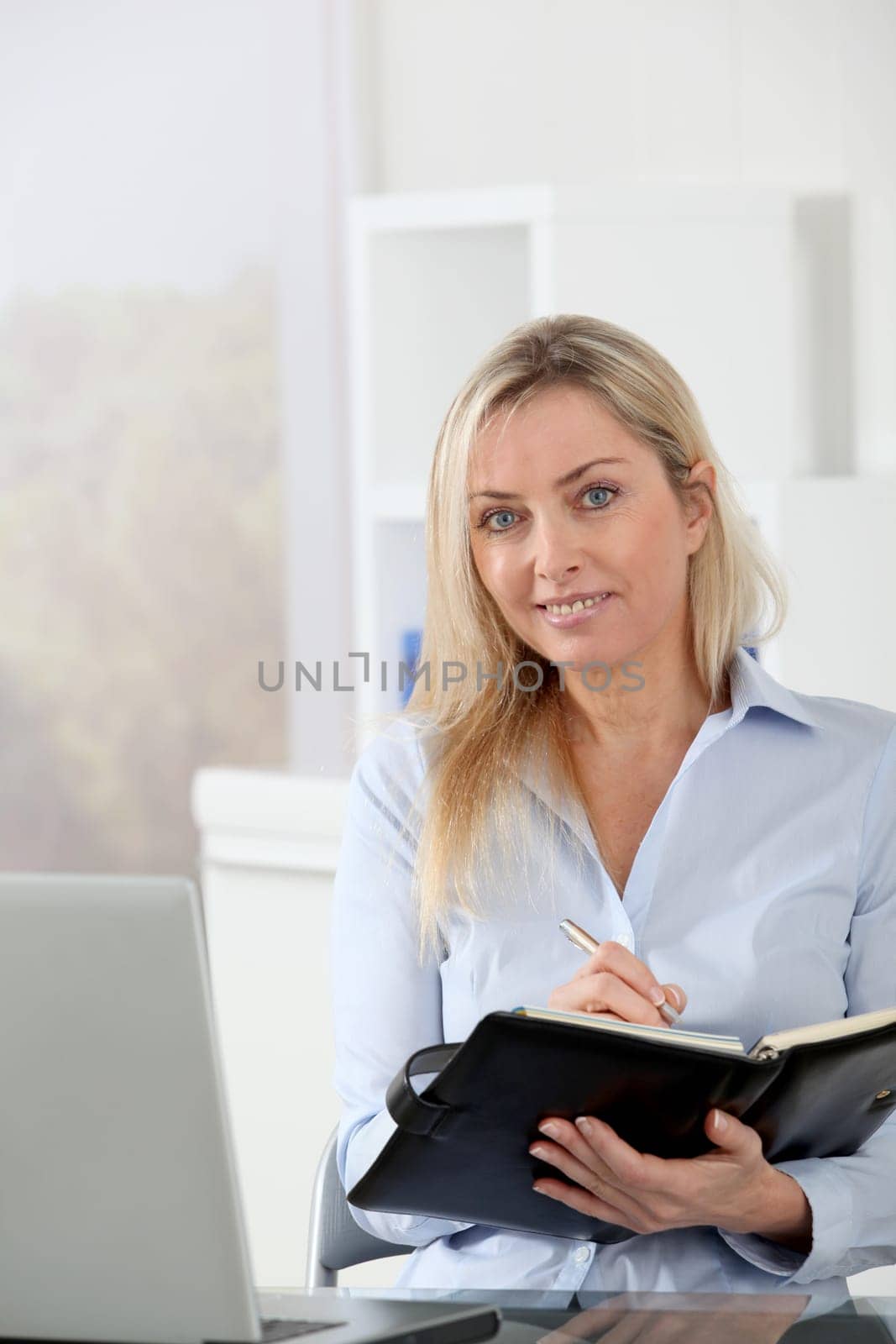 Beautiful blond woman working in the office