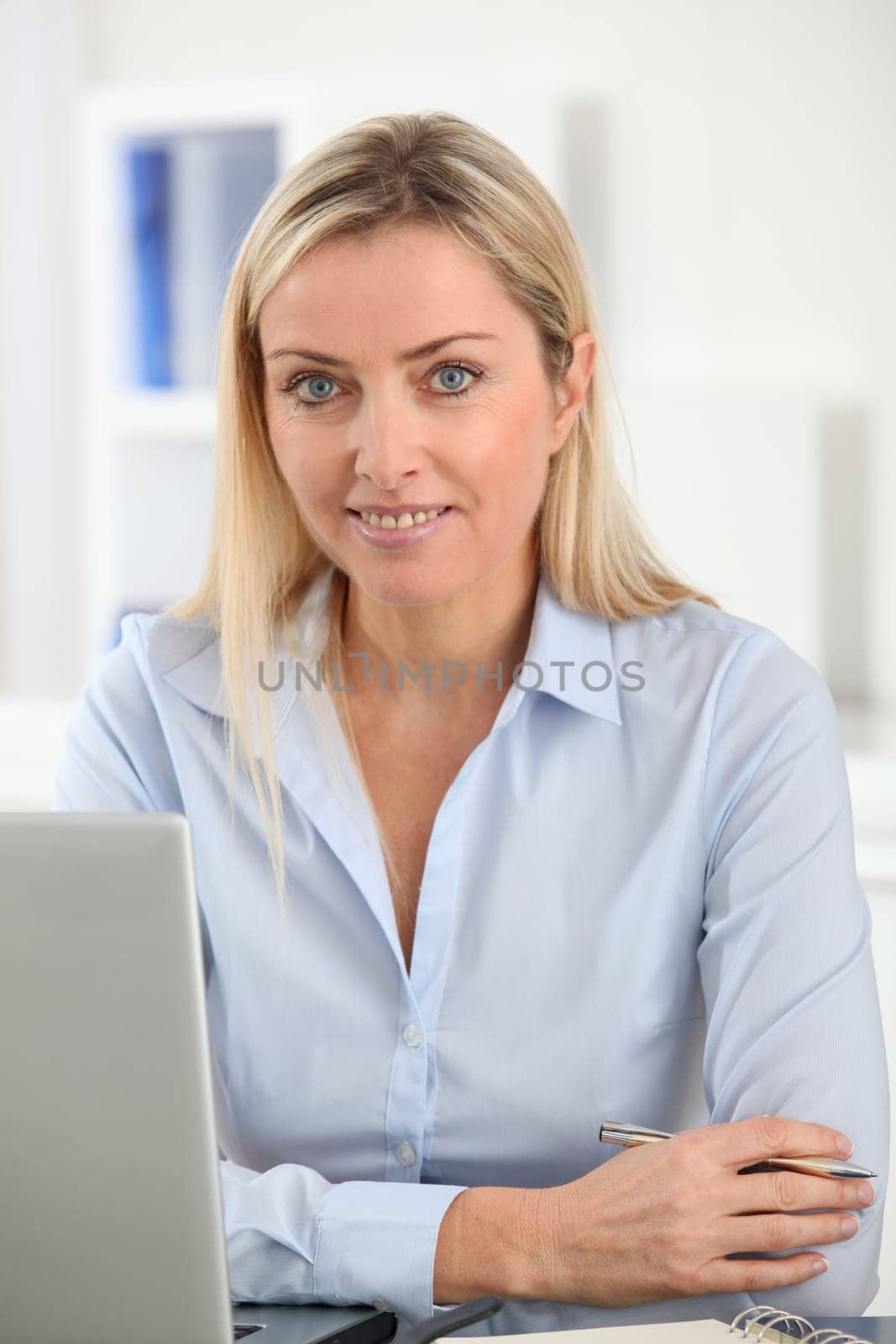Beautiful blond woman working in the office