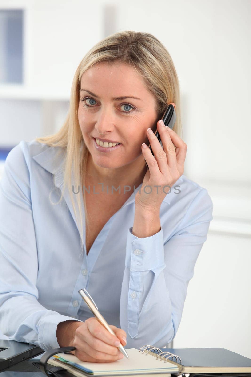 Beautiful office worker talking on the phone