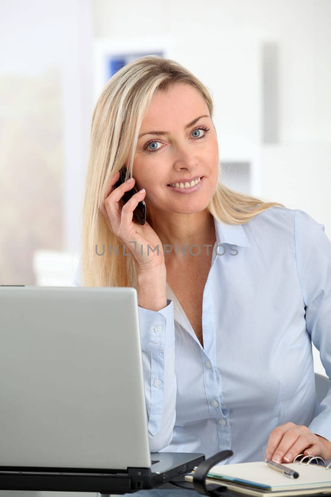 Beautiful office worker talking on the phone