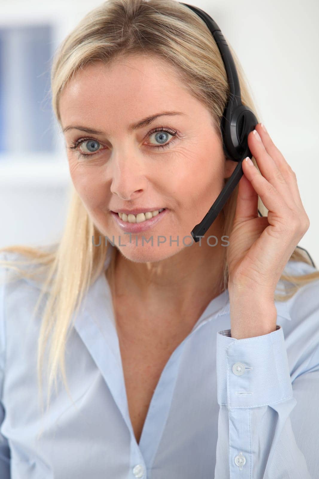 Closeup on blond woman with headset on