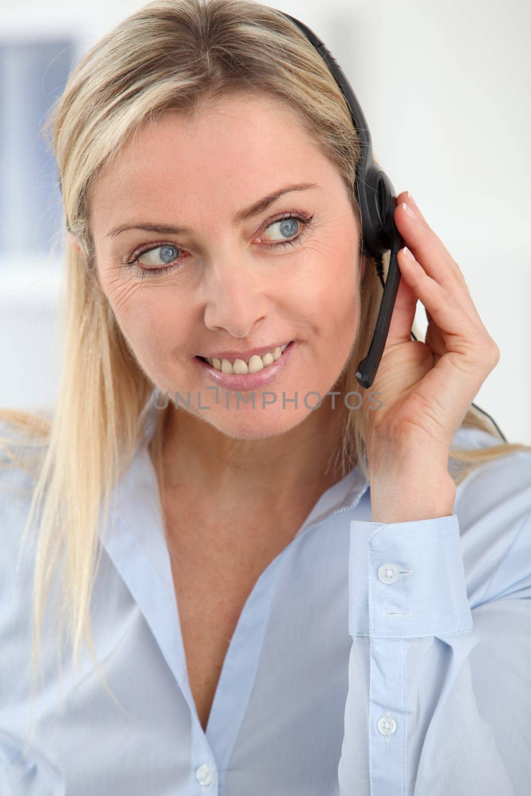 Closeup on blond woman with headset on