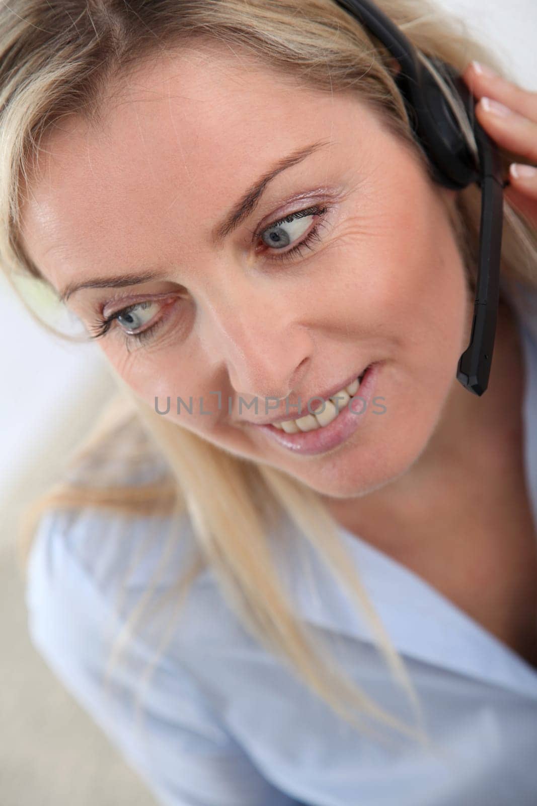 Closeup on blond woman with headset on