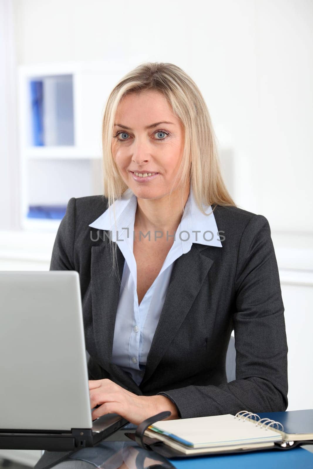Businesswoman in the office with laptop computer