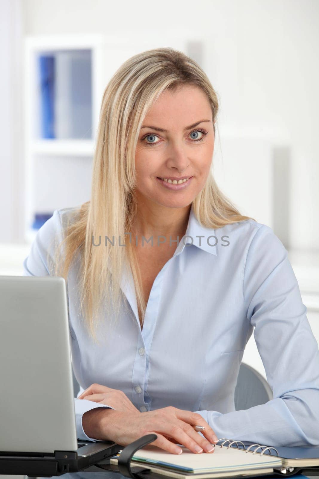 Beautiful blond woman working in the office