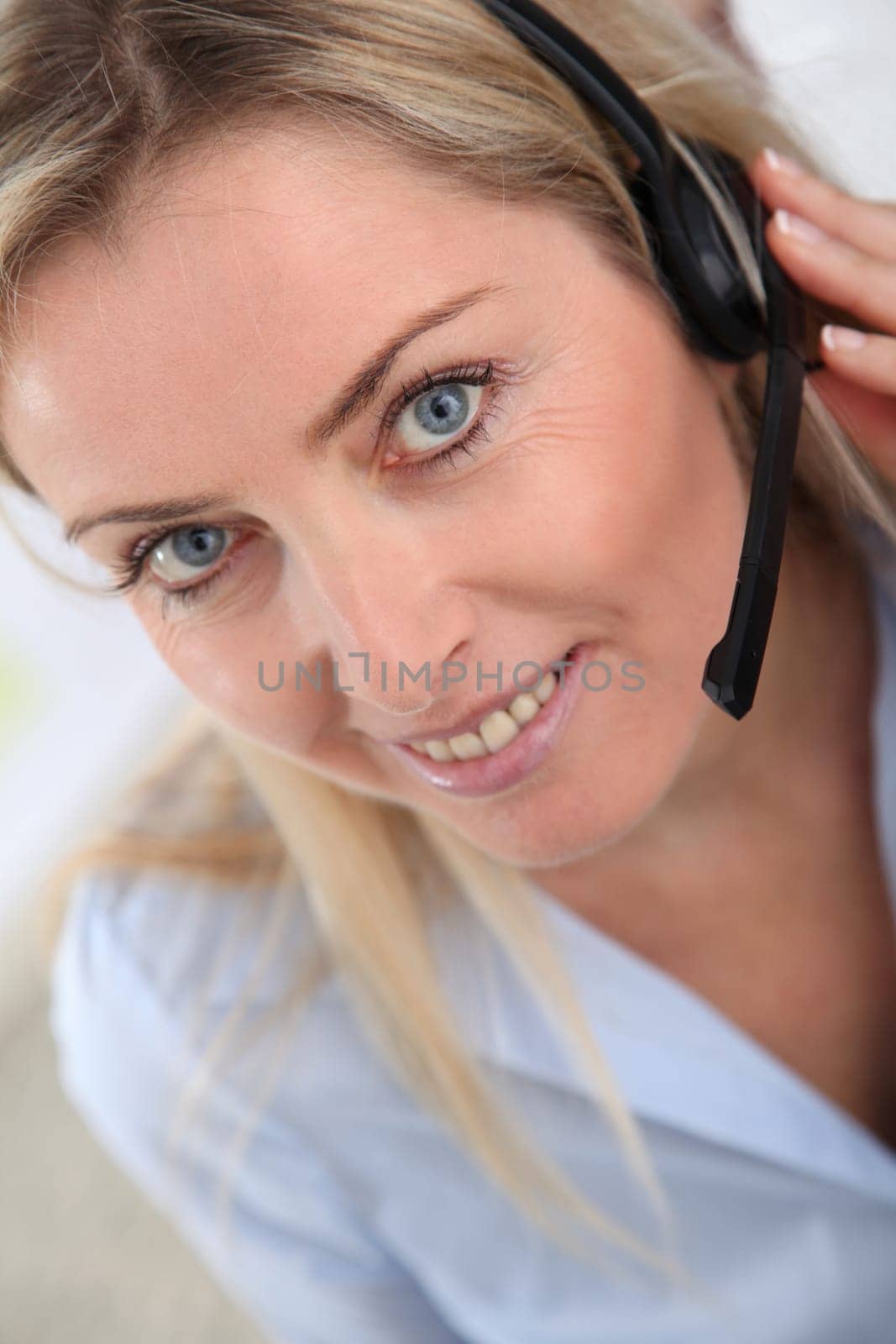 Closeup on blond woman with headset on