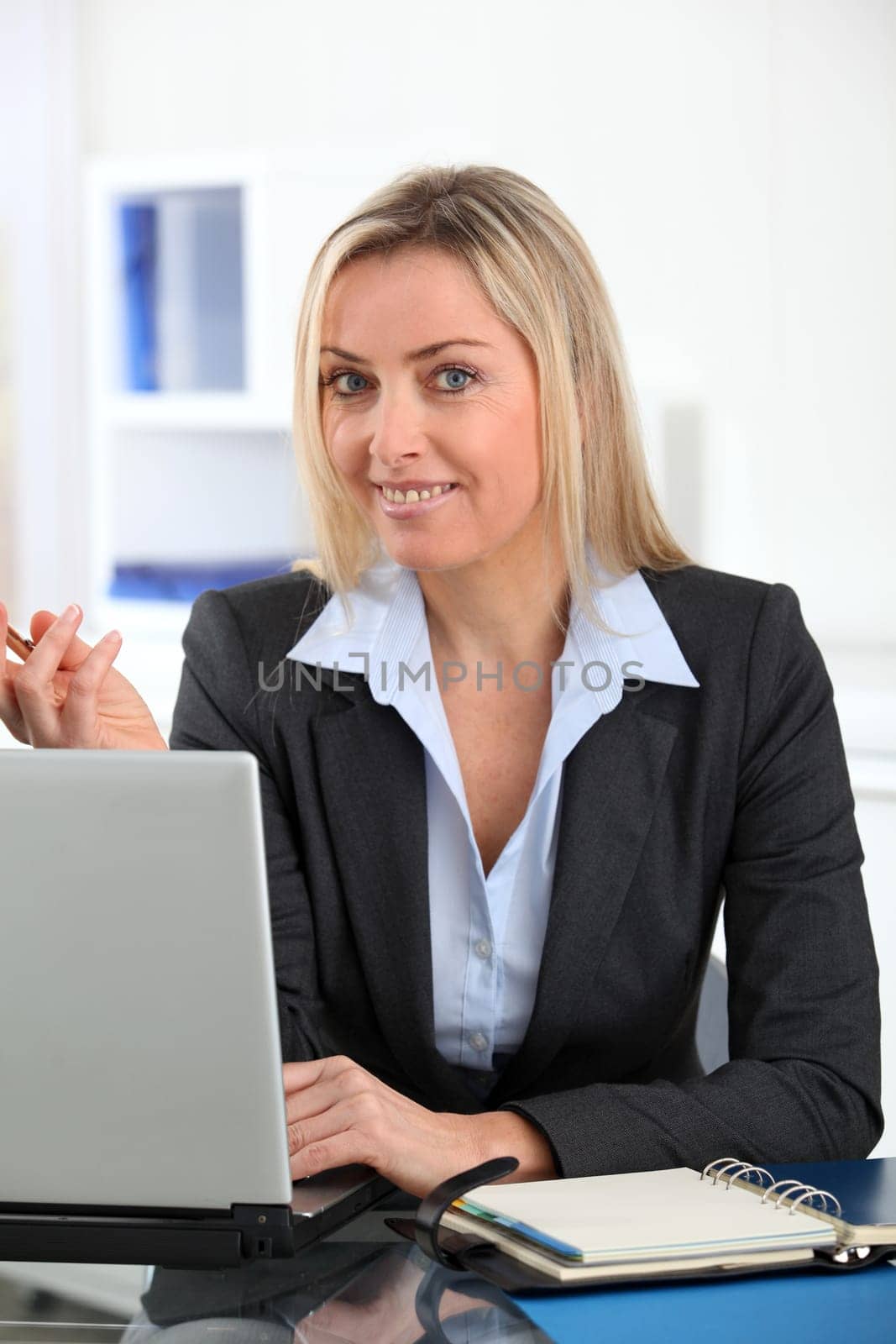 Businesswoman in the office with laptop computer