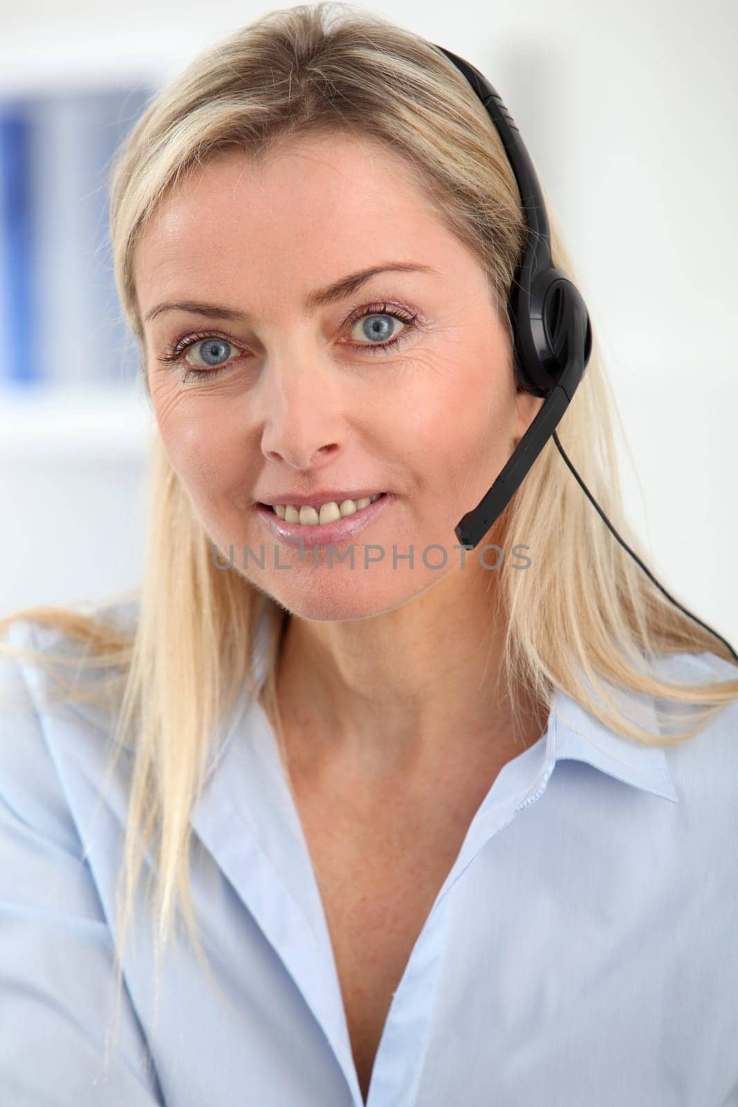 Closeup on blond woman with headset on
