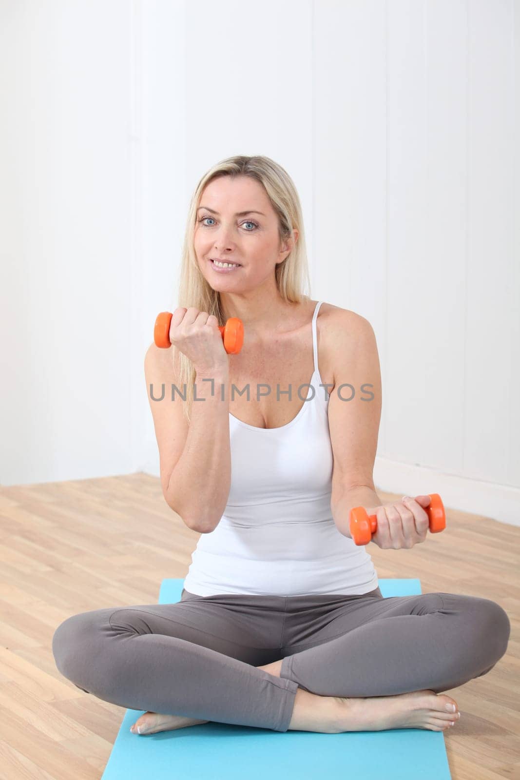 Beautiful blond woman doing fitness exercises