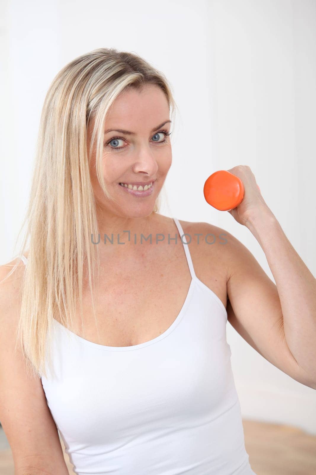 Beautiful blond woman doing fitness exercises