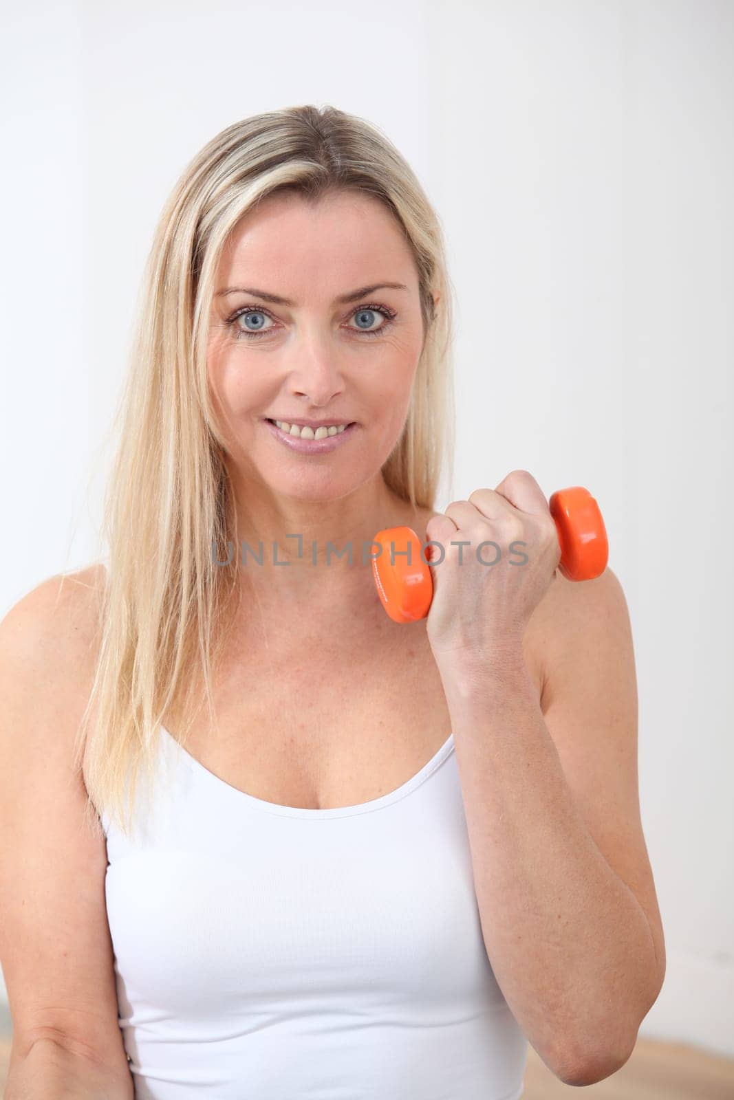 Beautiful blond woman doing fitness exercises