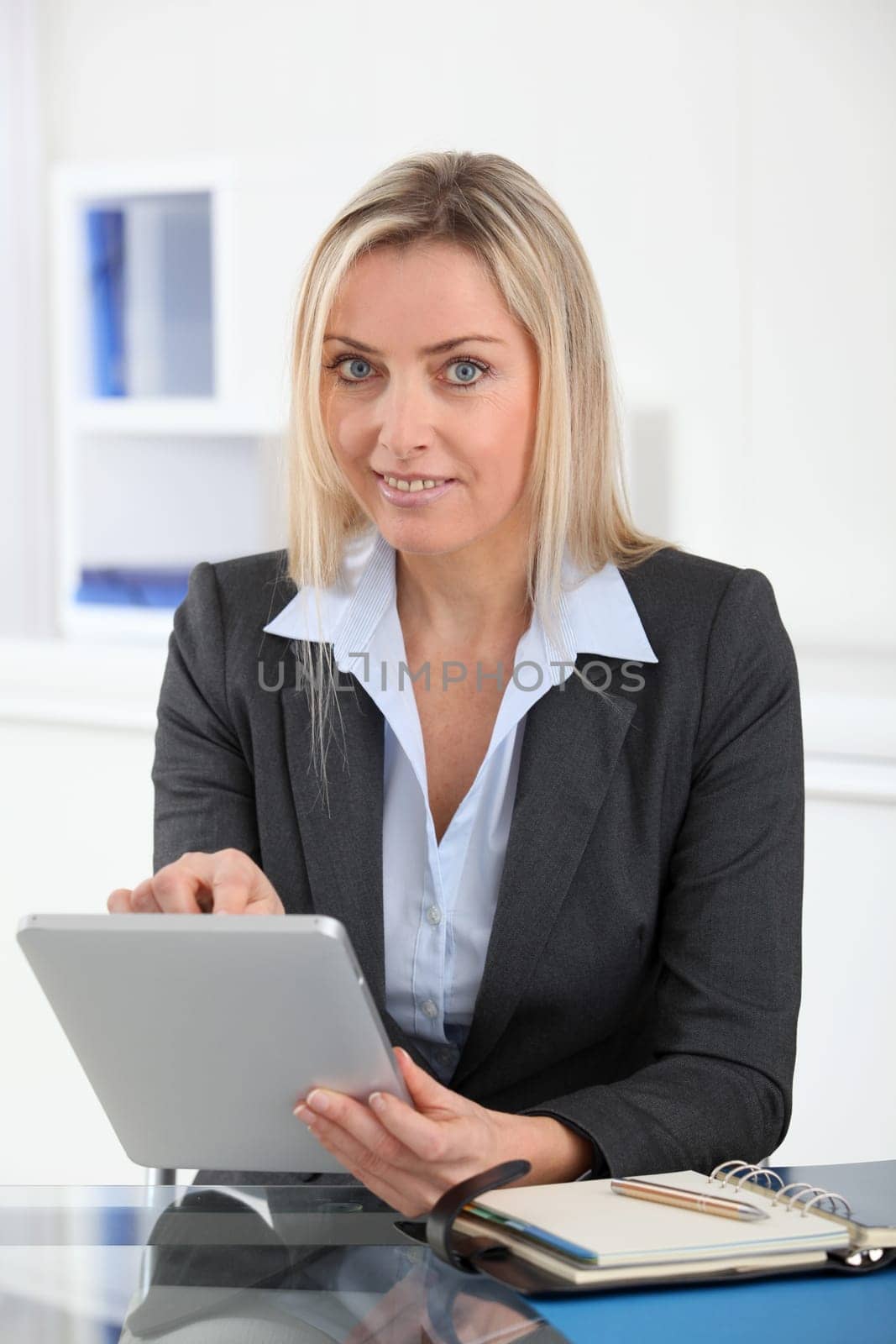 Businesswoman in the office with electronic tablet