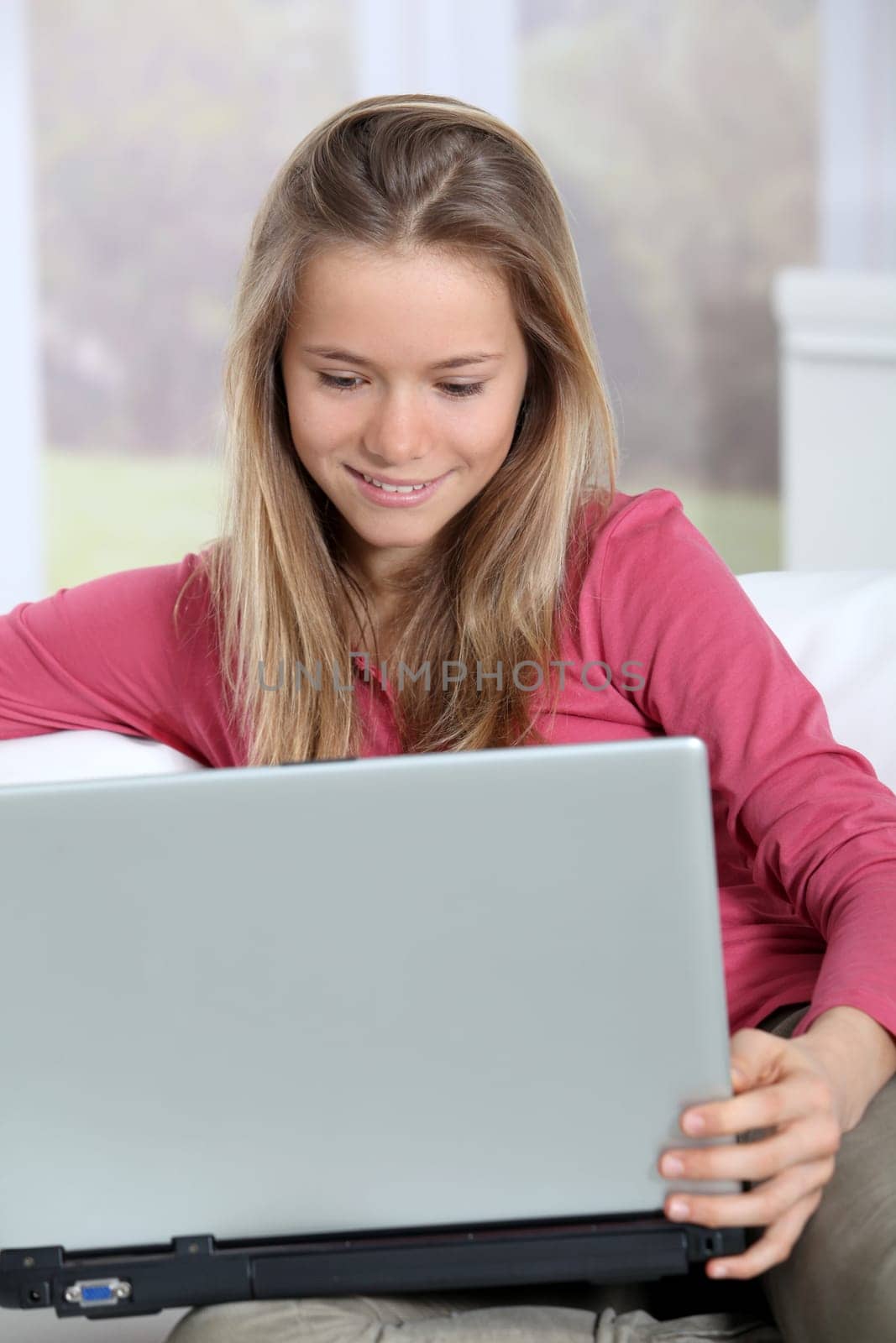 Blond teenager connected on internet at home