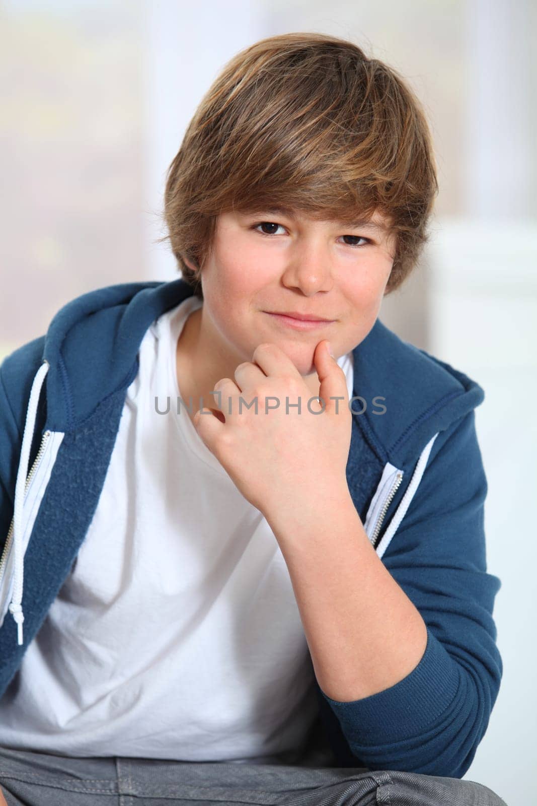 Portrait of young smiling boy with blue sweater