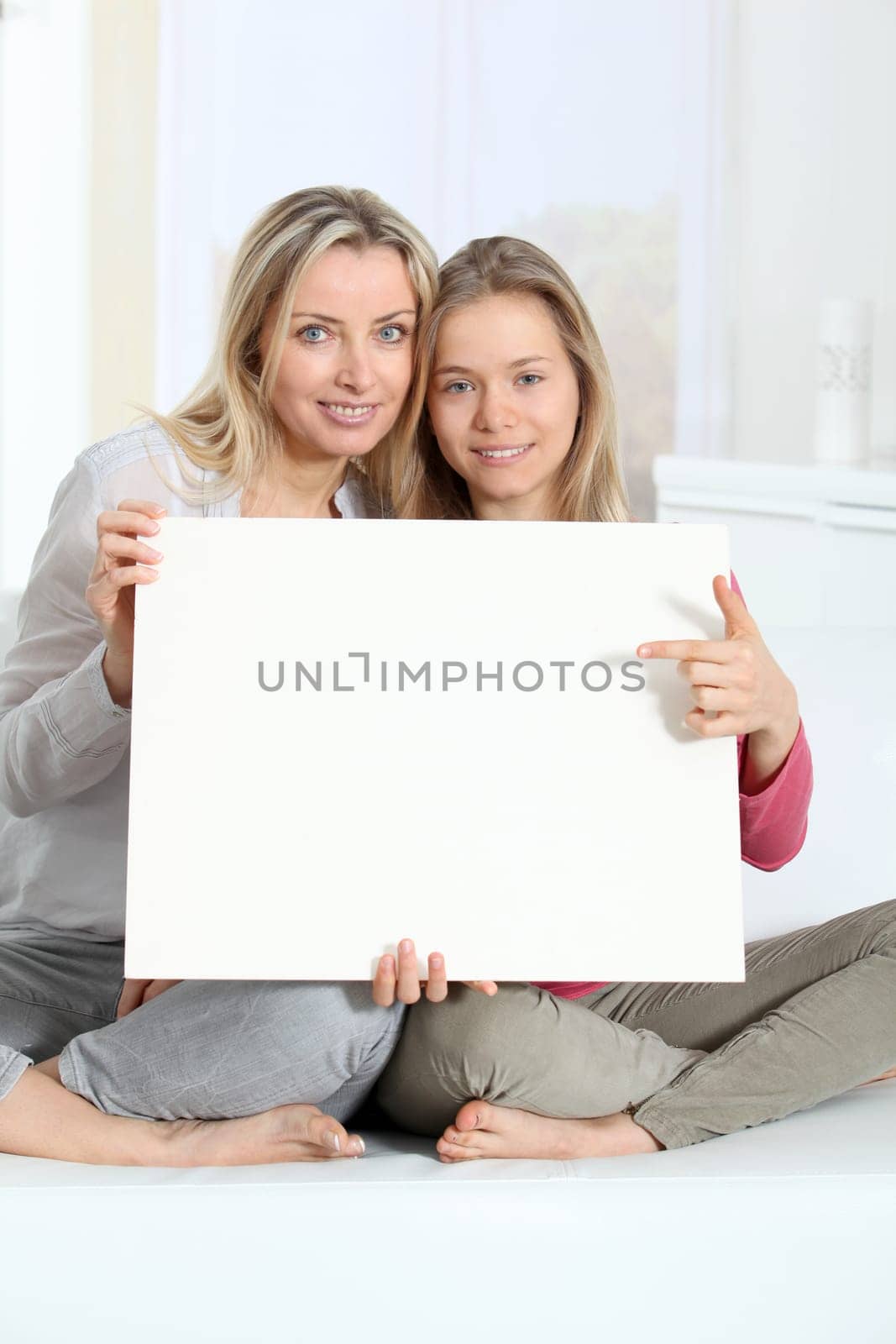 Woman and young girl holding whiteboard