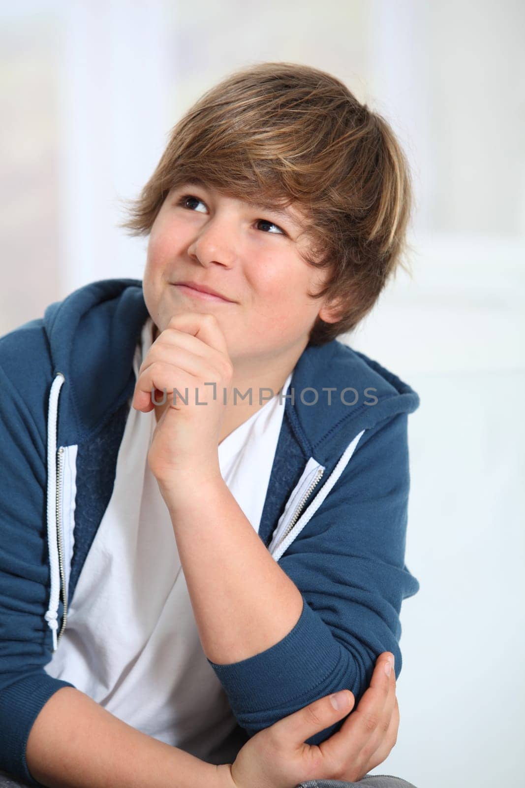 Portrait of young smiling boy with blue sweater