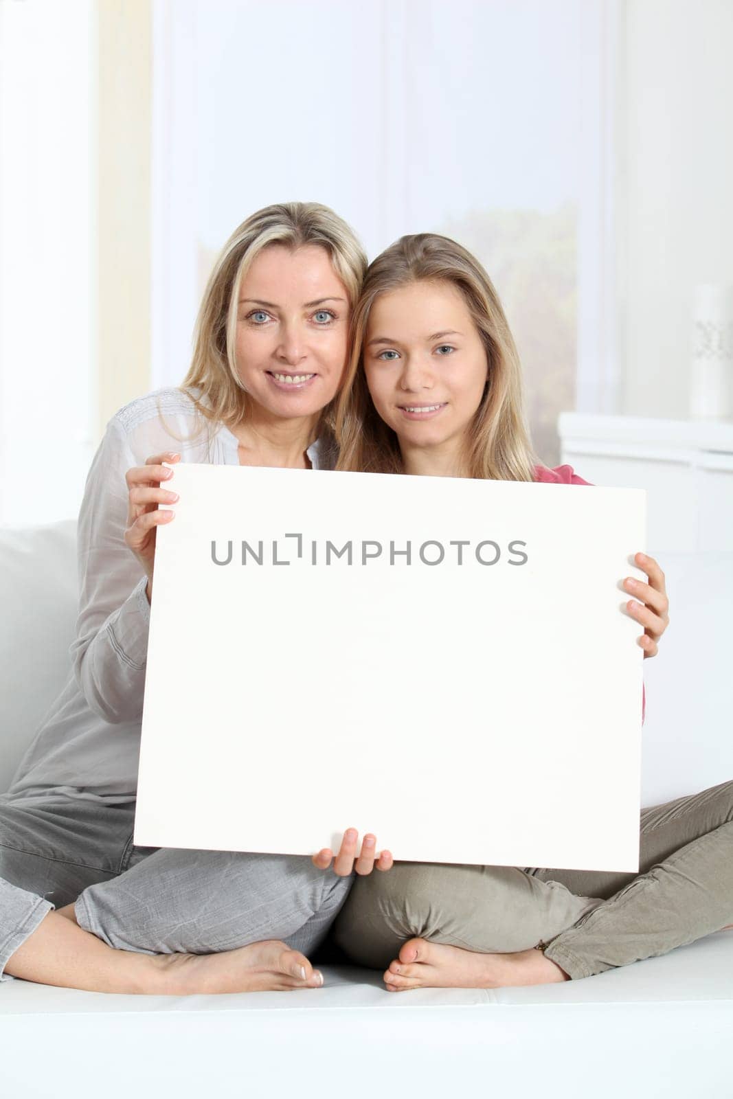 Woman and young girl holding whiteboard