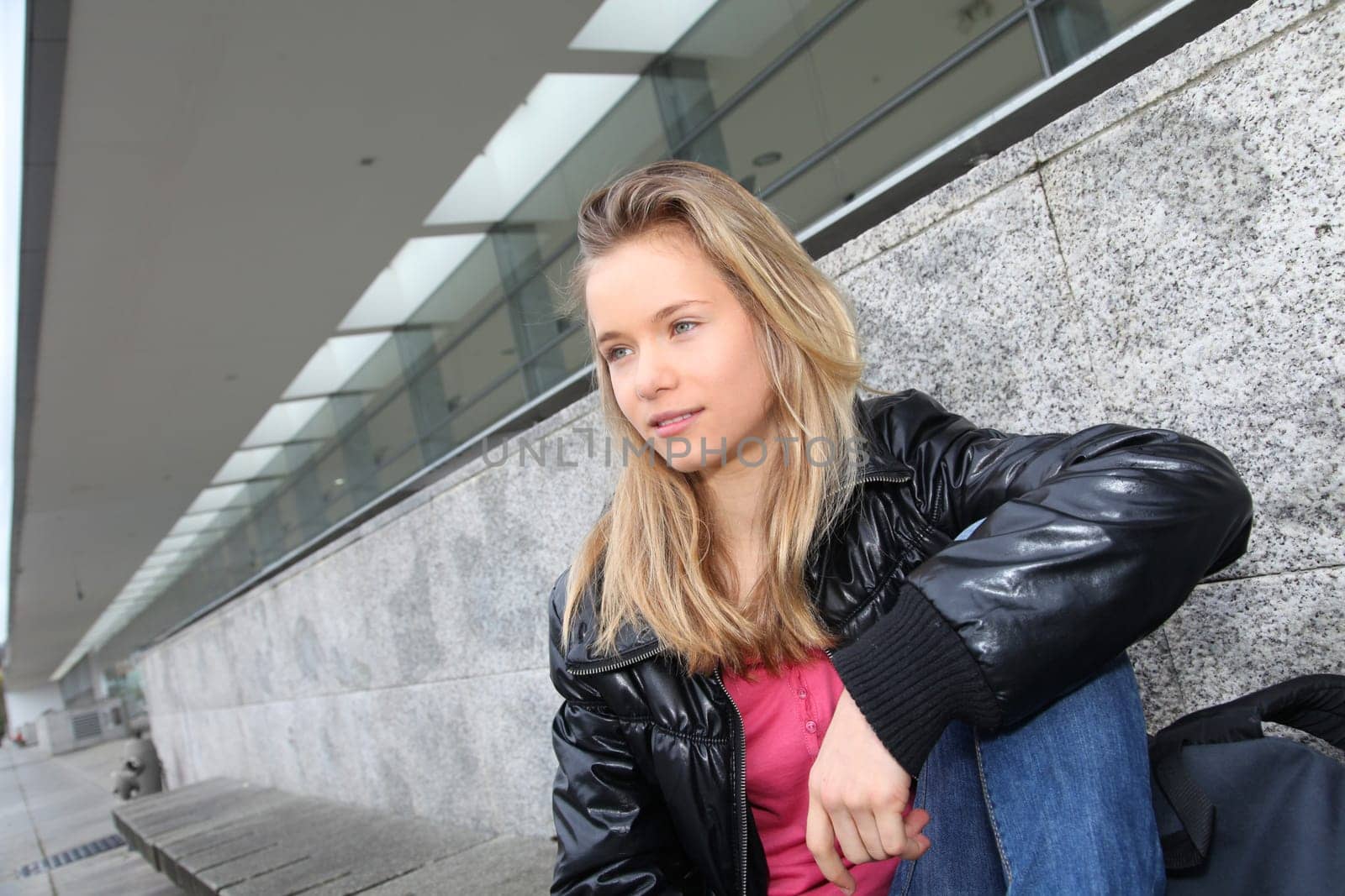 Closeup of teenage girl sitting on a school bench