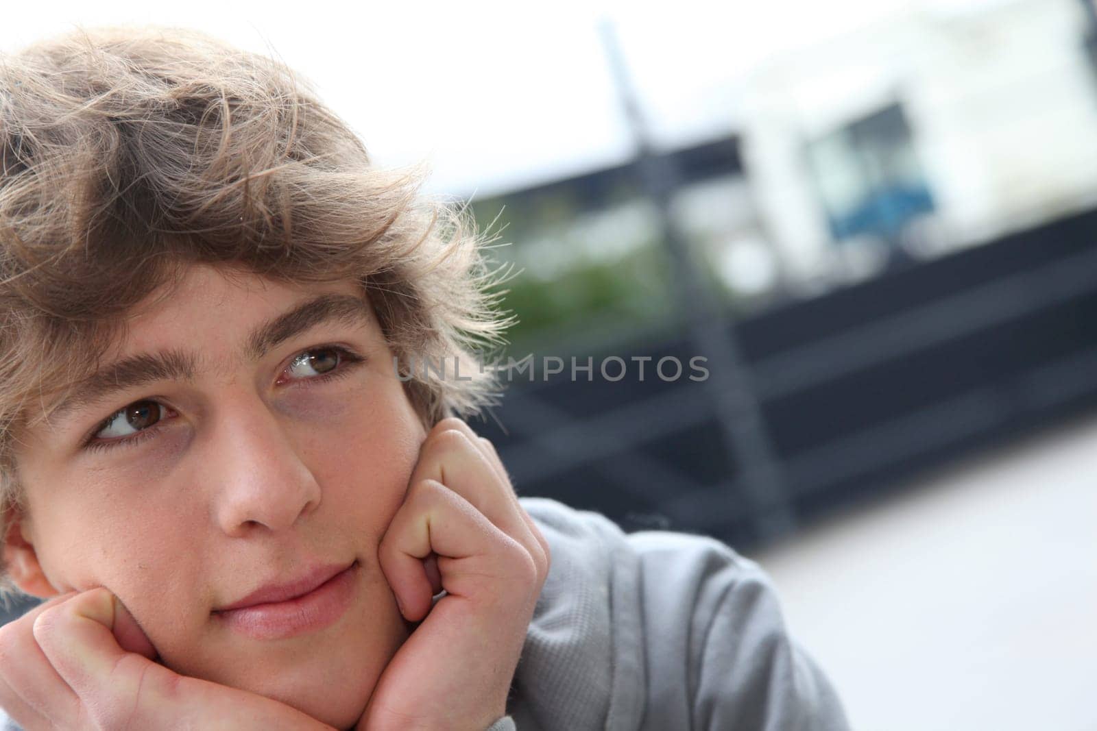 Portrait of teenage boy in front of school building