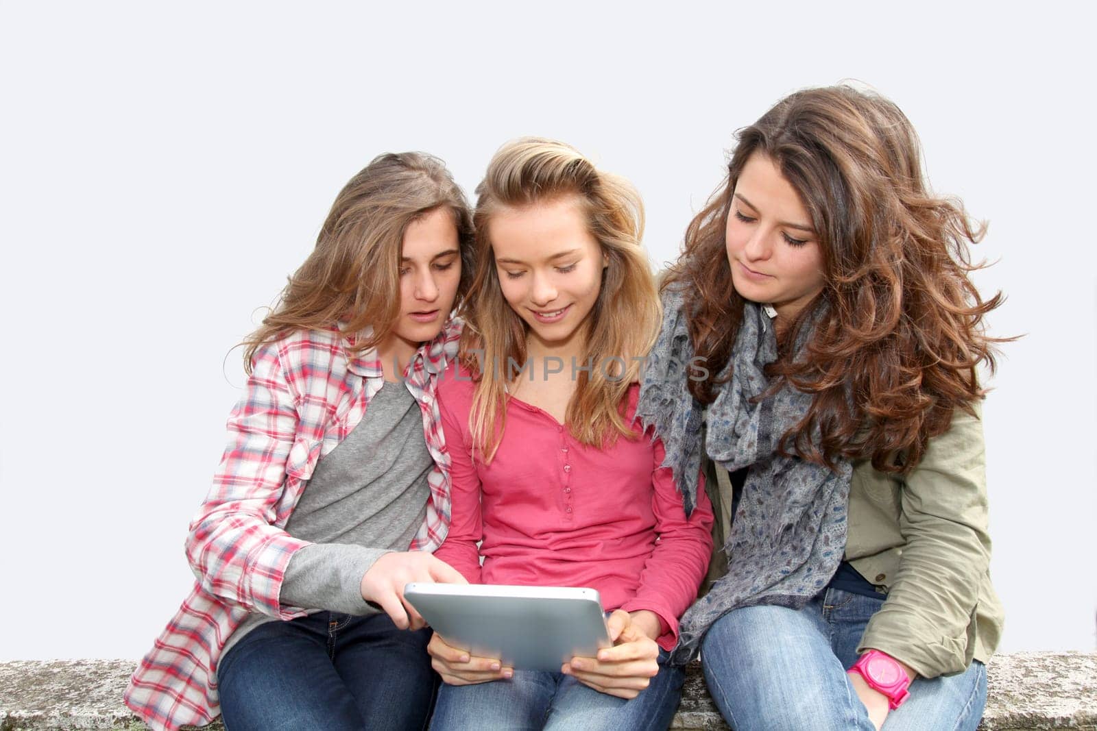 Group of teenage girls with laptop computer in school yard