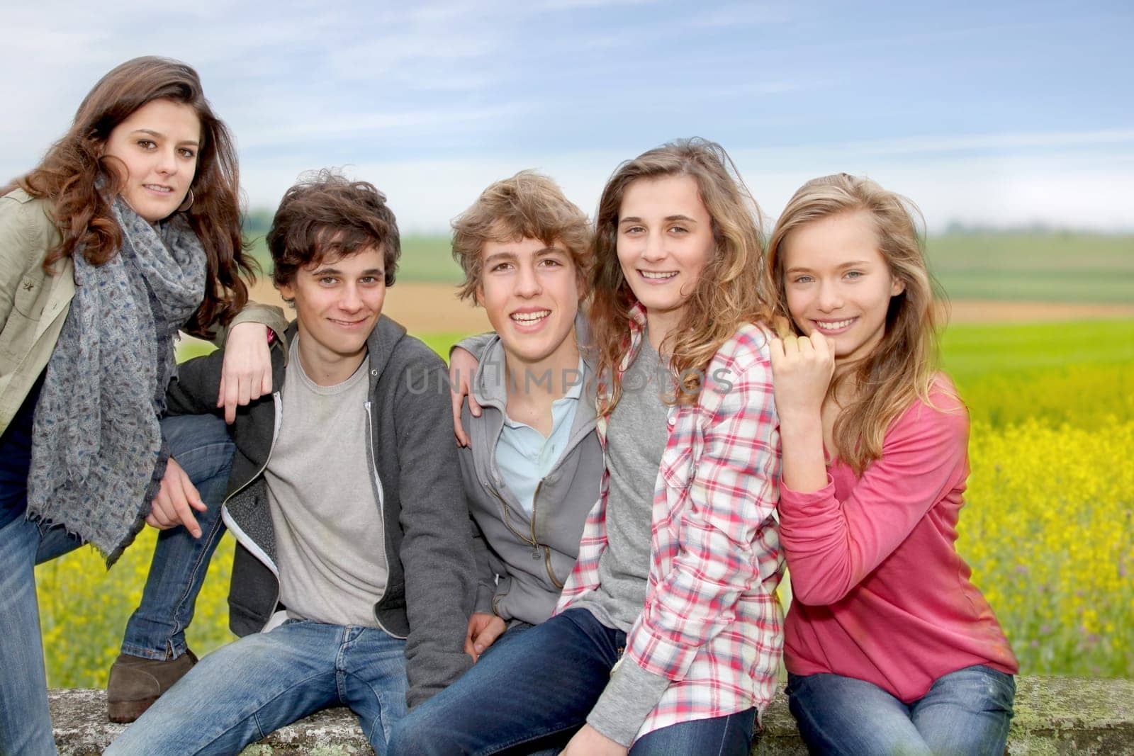 Group of teenagers sitting outside